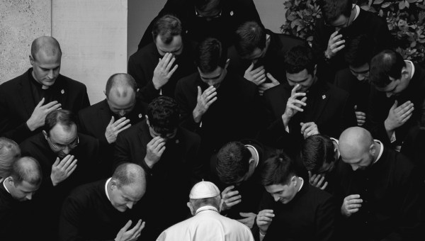 Pope Francis prays with priests at the end of a limited public audience at the San Damaso courtyard in The Vatican on September 30, 2020 during the COVID-19 infection